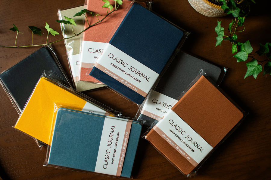 Set of eight colorful linen-lined journals